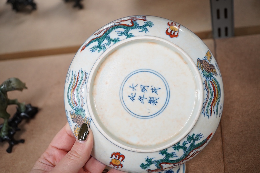 A pair of Chinese pedestal cups and three saucers. Condition - one cup severely damaged